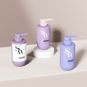 Three 300ml PE bottles with "SW" labels and lotion pumps are arranged on wood and white stands, ideal for shampoo.