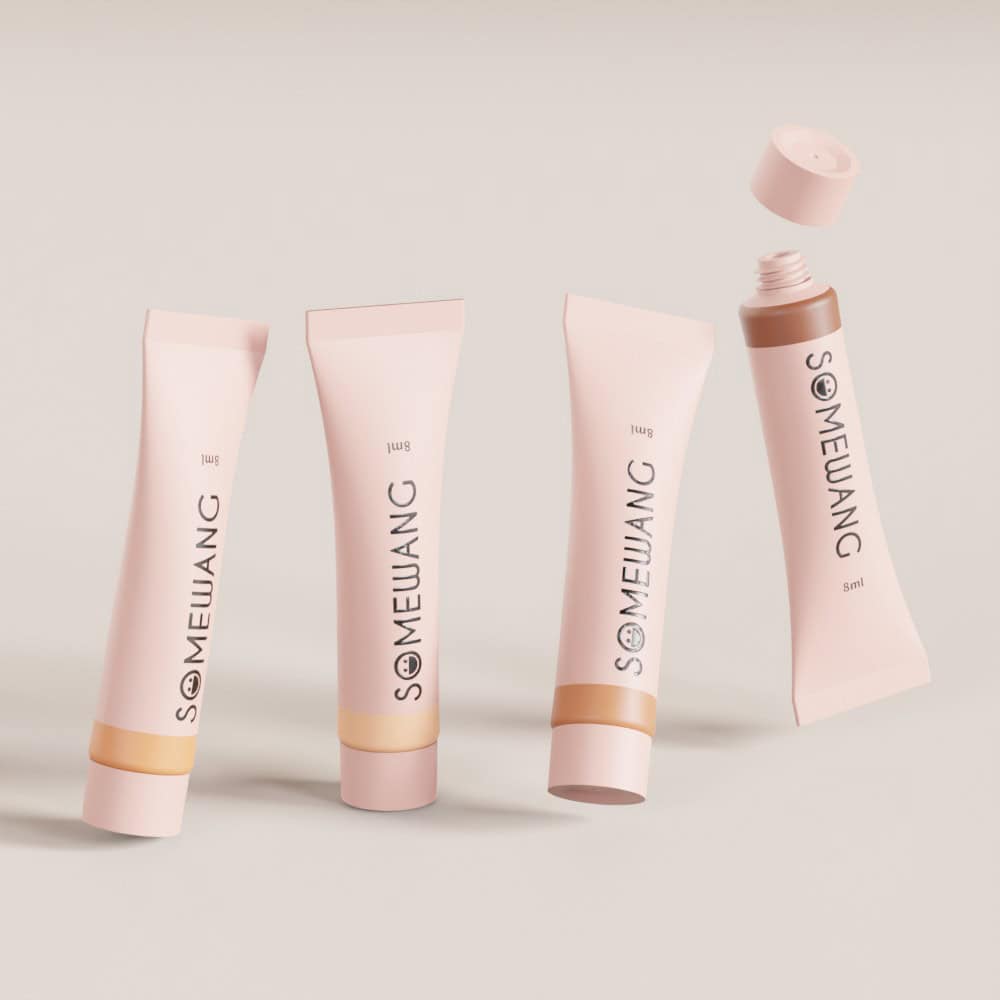 Four pink plastic cosmetic tubes are displayed against a neutral backdrop, with one open and tilted.