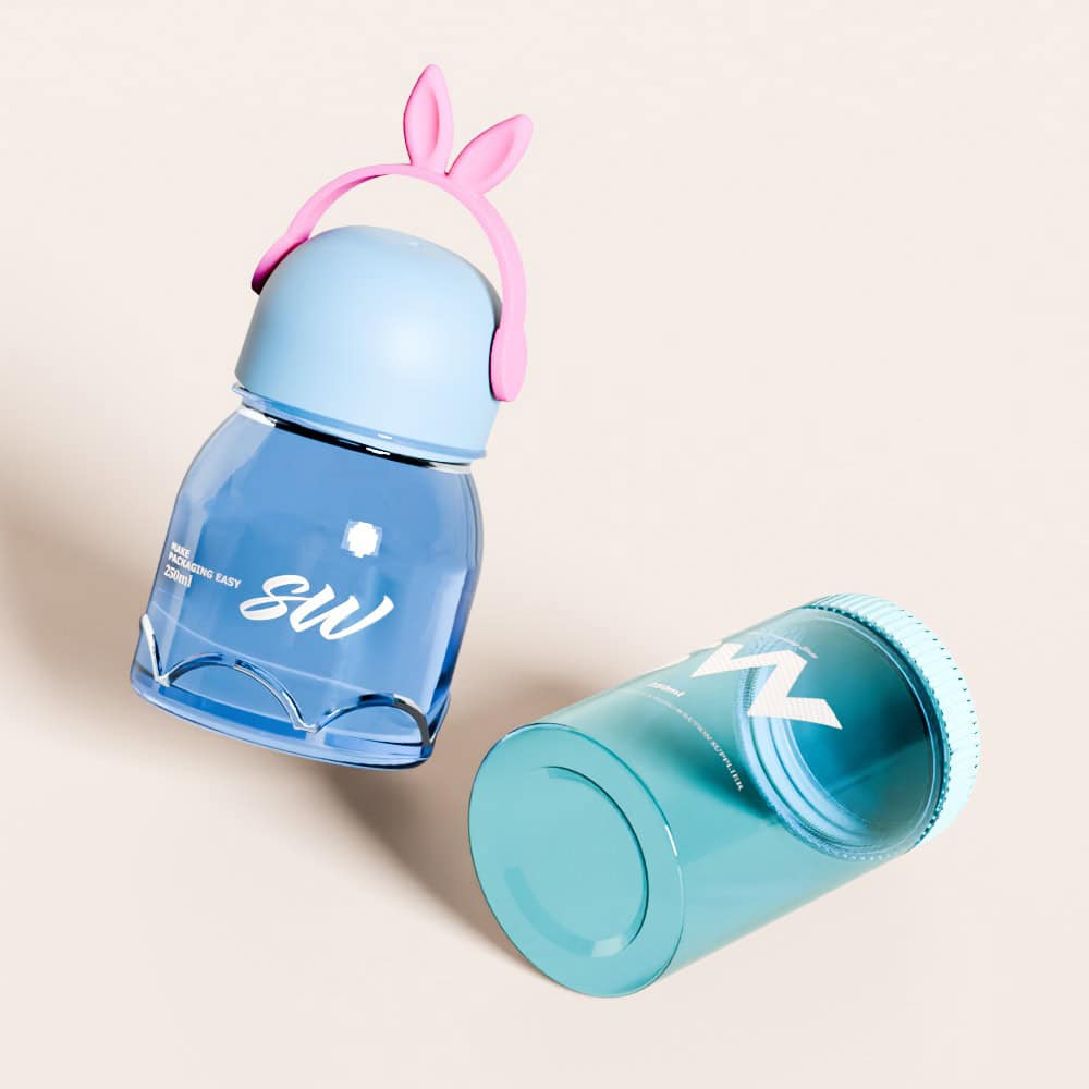Two blue plastic containers on a light background: one upright with a pink bunny lid, the other horizontal with a screw-on cap.