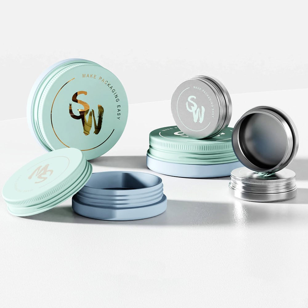 Metal tins with screw-on lids on a white surface, embossed with "SW" and "MS.