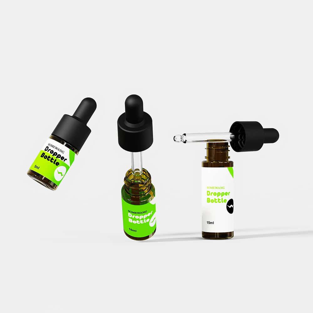 Four small brown dropper bottles with green-white labels: two standing, one lying down, one with dropper removed.