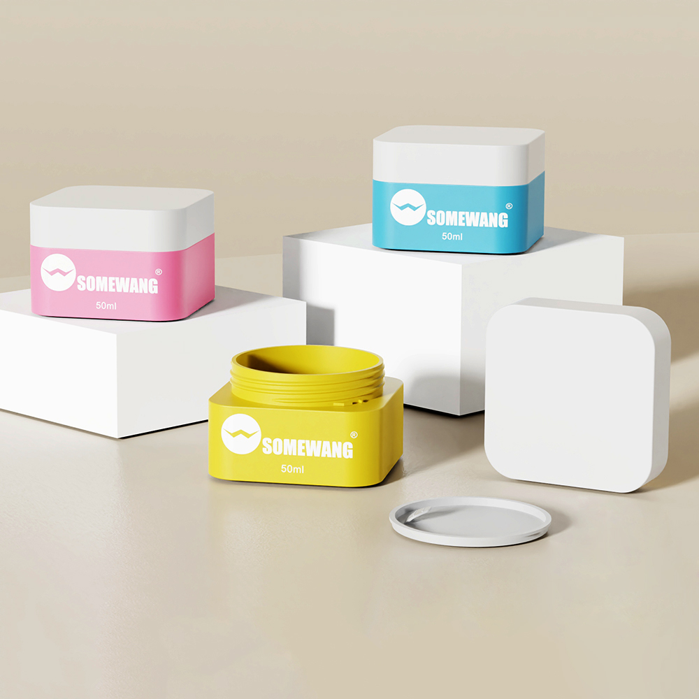 Three square 50ml SOMEWANG jars—pink, blue, and open yellow—are displayed on white blocks.