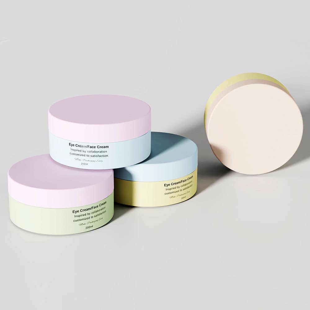Four pastel cream containers are on a plain background: three stacked with labels visible and one upright with a blank side.